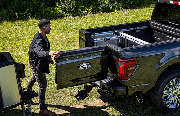 A man opening a truck bed