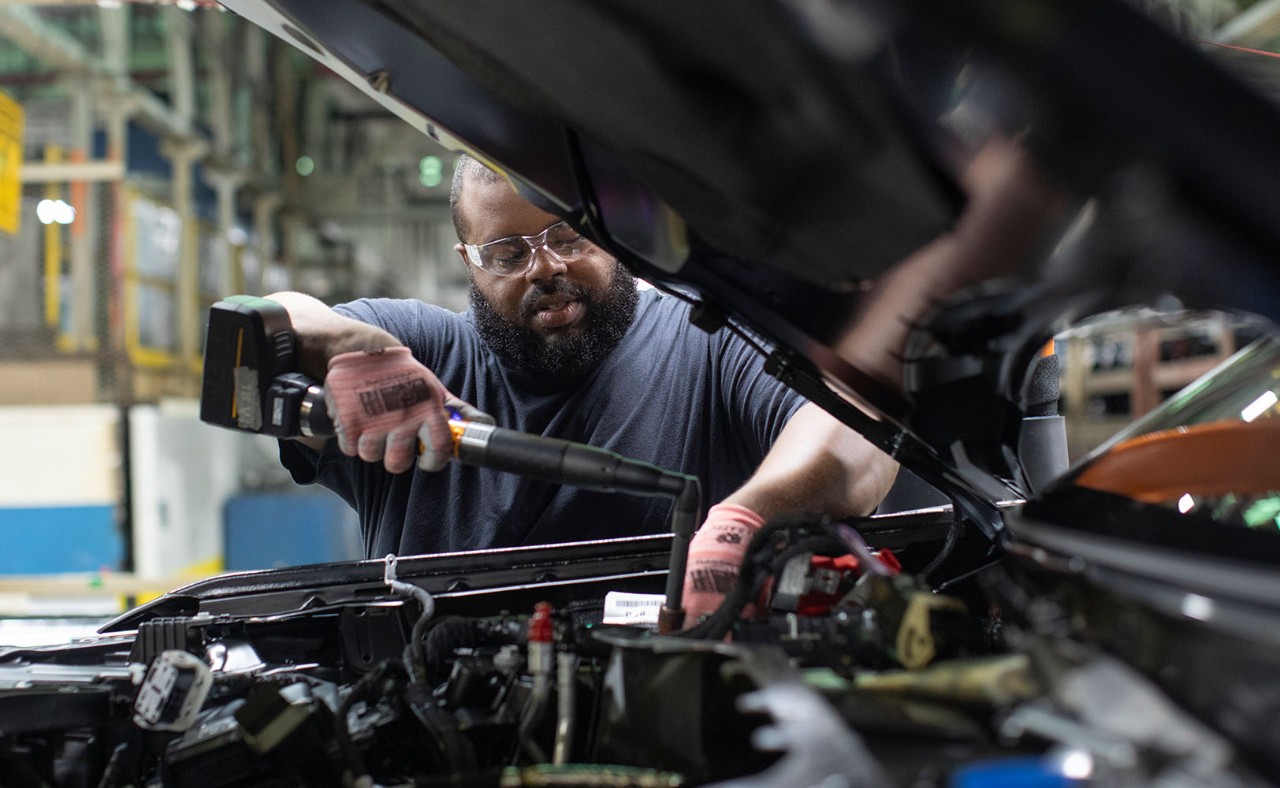 A man is working on an assembly line